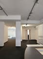 modern open hallway, white walls, black floor, multiple spotlights, white shelf