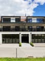 Modern 2-story house, white exterior, large glass windows, solar panels, balconies, garage