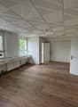 empty room, white walls, windows, wooden floor, ceiling with panels