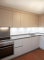 modern kitchen, silver AEG appliances, stainless steel sink, ceramic tiles, tiled backsplash