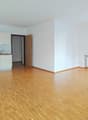 empty room, white walls, hardwood floors, white kitchen cabinets, sink, oven