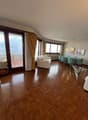 Living room, wooden floor, balcony, glass windows, dining table, white sofa