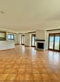 tiled floor, fireplace, sliding doors, windows, kitchen, hallway