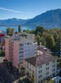 Buildings in a town near a lake and mountains