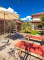 outdoor area with loungers, patio umbrella, small table, mountain view