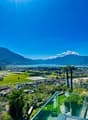 Aerial view of a town with mountains, a lake, and a clear sky