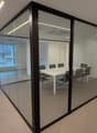 Glass walls, meeting table, modern chairs, large windows