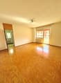 empty room, wooden parquet flooring, sliding glass doors, radiator, ceiling fan
