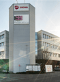 Multi-story office building with Growa and SBI Software Beratungs-Institut AG logos, parking spaces in front of the building