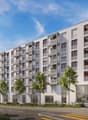 Multi-story apartment building with balconies, parking spaces, and landscaping in the front