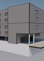 Three-story building, multiple windows, garage at base