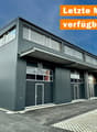 warehouse style building, multiple doors and windows, garage entrance