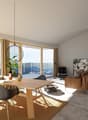 Spacious open-plan living and dining area with large windows offering a scenic view. The room features a wooden dining table with modern chairs, a comfortable leather sofa, and a decorative pendant light. The space also includes a balcony or terrace acces