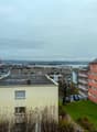 Aerial view of residential buildings with waterfront in the distance