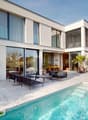 Modern white house, two stories, large windows, pool, outdoor seating area, potted plants