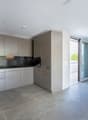 modern kitchen, gray cabinets, granite countertops, integrated appliances, sliding glass door