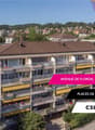 A modern multistory building with balconies and internal parking for motorbikes.