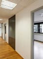 wooden floor, white walls, multiple windows, open glass door