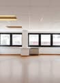 empty room, hardwood floor, two windows, two power outlets, central pillar