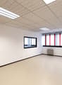 Empty room, white walls, floor and ceiling, square windows, windows with red and white stripes
