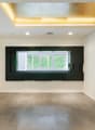empty room, white walls, wooden floor, large window, yellow accent wall