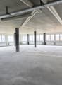 large open room, lots of windows, industrial look, exposed pipes