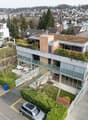 3 story house, green roof, glass balcony, garage, car parked