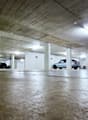 underground parking garage, number markings on ceiling, cars parked