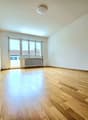 empty room, hardwood floors, white walls, large windows, white ceiling, white radiator