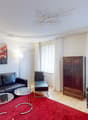 leather couch, glass tables, wooden cabinet, painting, red carpet