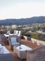 outdoor seating area, coffee table, flowerpots, mountain view