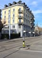 yellow building, multiple balconies, street, tram tracks