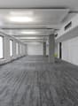wide hallway, white walls, large windows, gray carpet