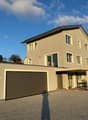 2 story house, beige exterior, large garage, brick driveway