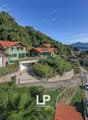 House on a hillside with lake view, red roof, garden, parking place, solar panels