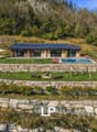Detached house with solar panels, swimming pool, landscaped garden with stone walls