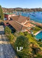 Large house with a swimming pool, located on a hill with a view of the lake