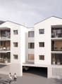 modern building, raised ground floor, balconies, garage, surrounded by mountains