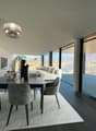 Dining room, modern design, large windows, view of the sea and mountains, dining table with chairs, beige rug, ceiling lamp, indoor plant, side table with lamp