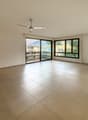 empty room, glass sliding doors, balcony, beige tile floor, ceiling fan, power outlets
