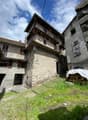 stone building, balconies, tiled roofs, two storeys