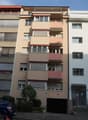Multi-story apartment building, balconies, underground parking, entrance