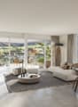 open plan living room, dining area, couch, coffee table, balcony, dining table, chairs, rug, lamps, plants, artwork