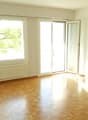 Hardwood floor, white walls, large windows, balcony, sliding doors, radiators