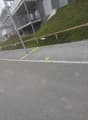 Road with sidewalk with designated parking places