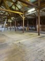 Wooden floor, wooden trusses, windows on the side wall