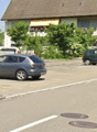 Multiple parking spots with cars parked on both sides of the street.