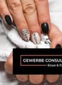 Manicured nails with black and white nail art design.