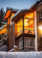 Wooden chalet style, multi-storey, balconies, illuminated windows, street lighting