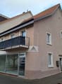 3 story house, brown roof, glass windows, glass door, balcony, glass wall